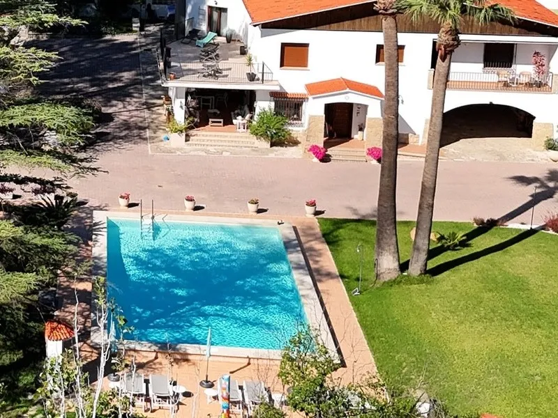 Swimming pool and lawn at La Vida Soñada, seen from above, setting for a women-only non-sexual naturist retreat