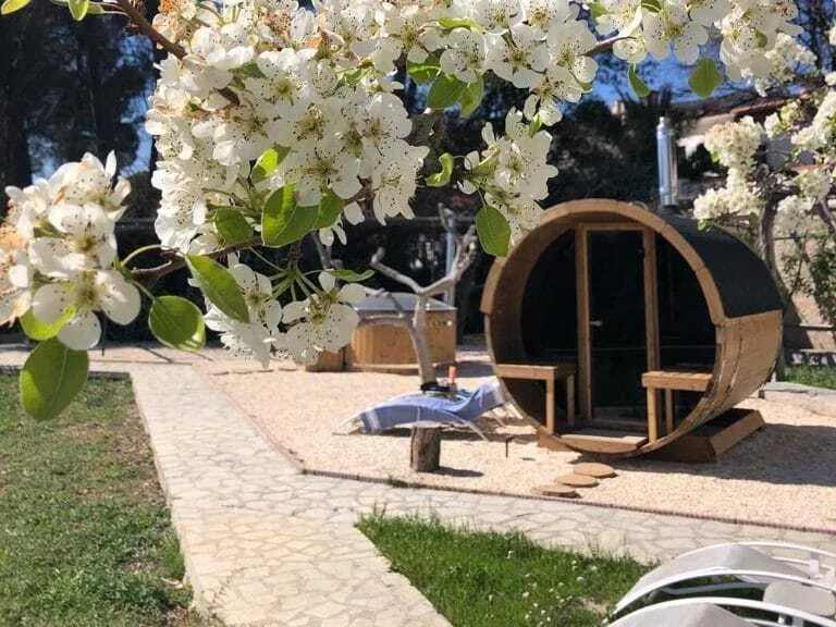 Barrel sauna among blossom in the garden at La Vida Soñada